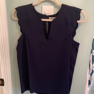 Scalloped navy sleeveless shirt.